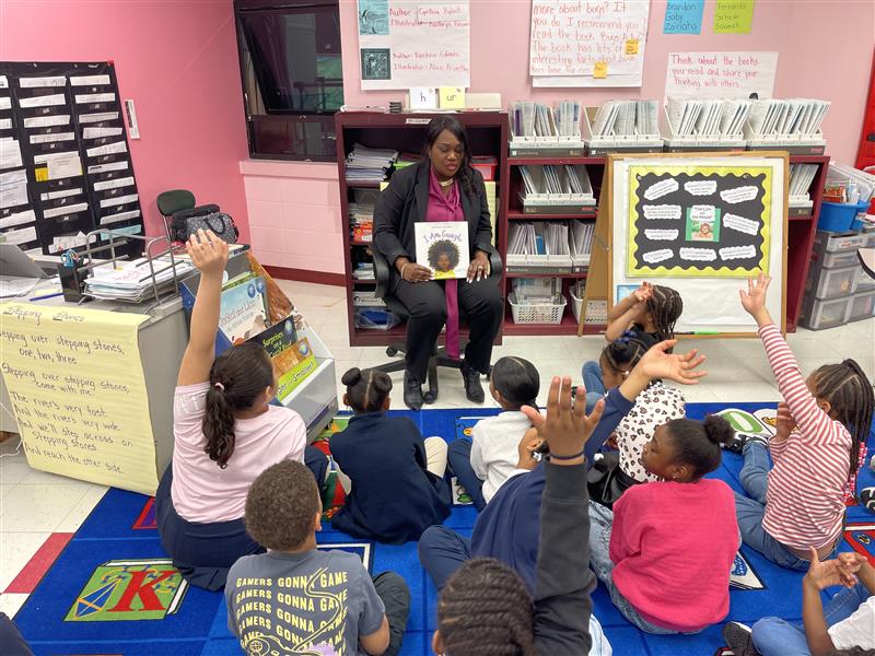 Dr. La'Quetta Small reads to children at Dr. Martin Luther King Jr. School Complex